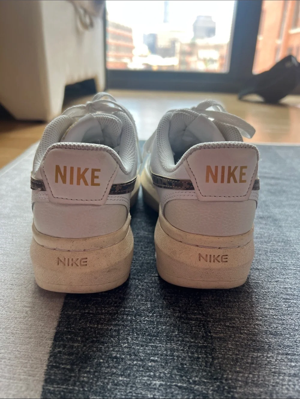 Nike sneakers with leopard print swoosh